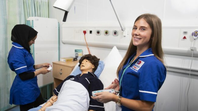 Health students with medical dummy