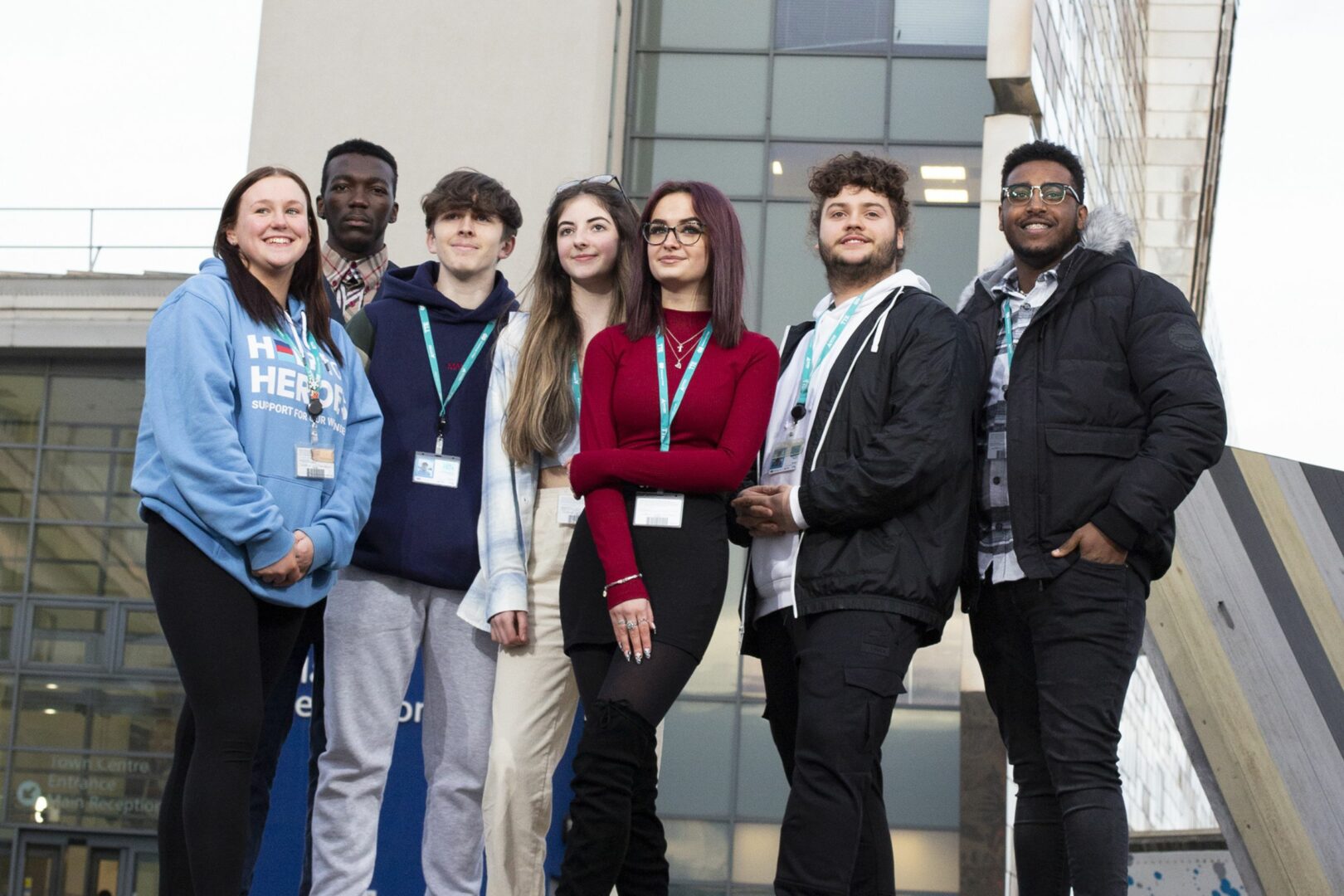 Seven students stand outside Middlesbrough College building