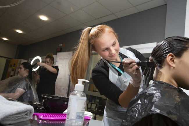 Student dyeing hair