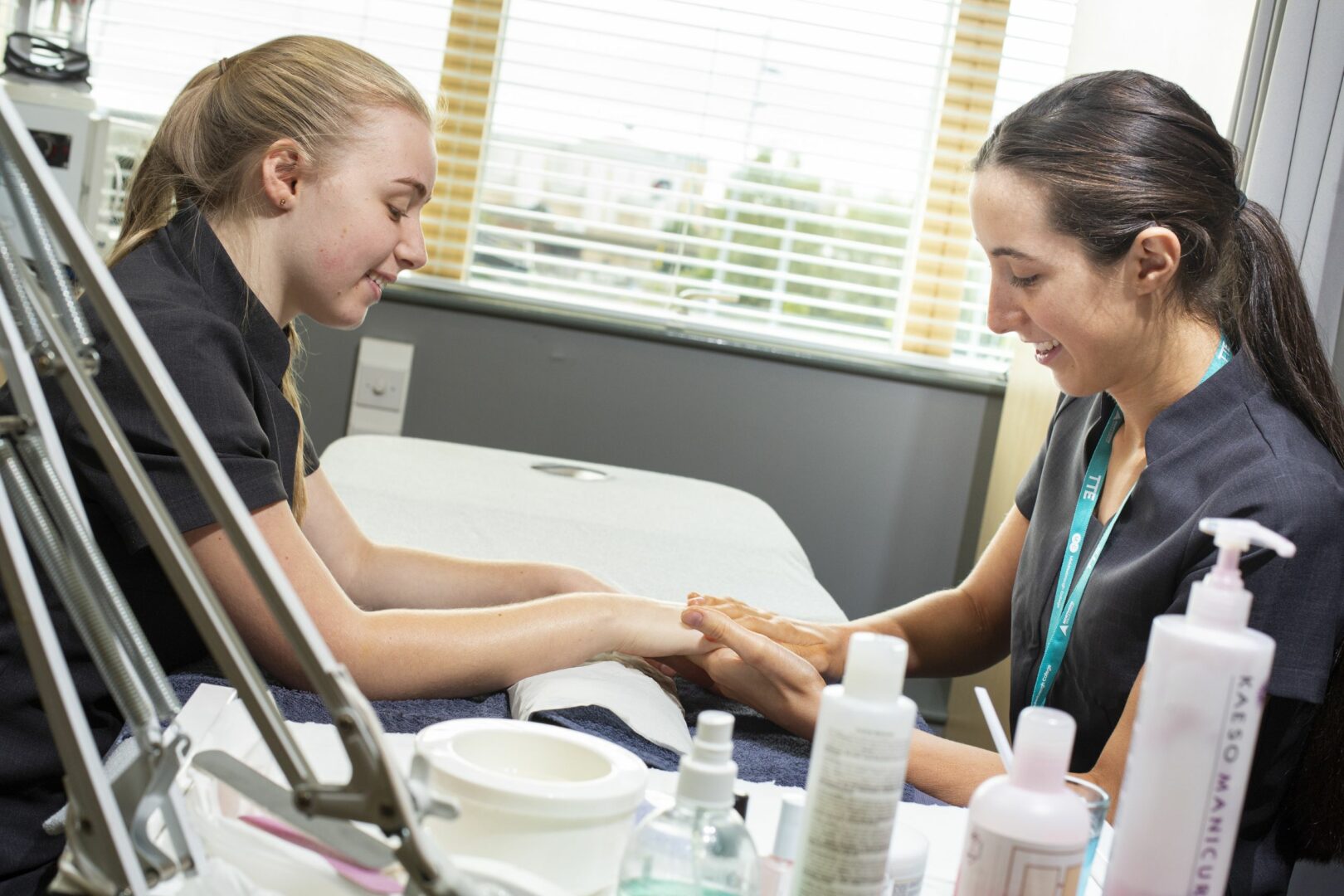 Student giving manicure to student