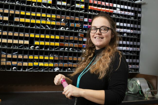 Student with hair dye tubes
