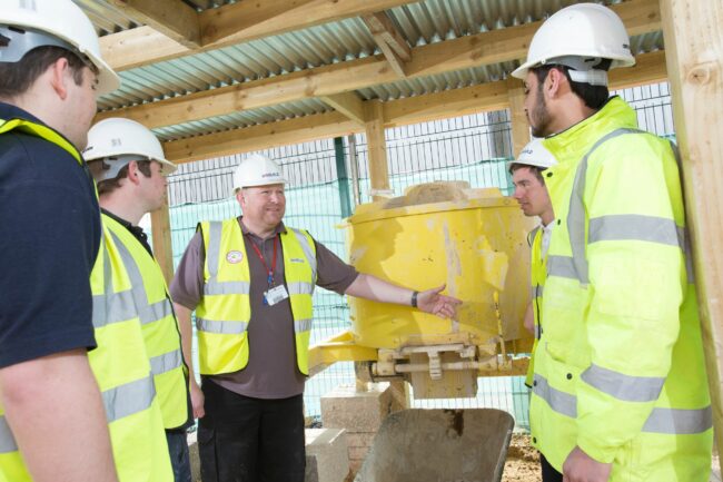 Construction students with tutor