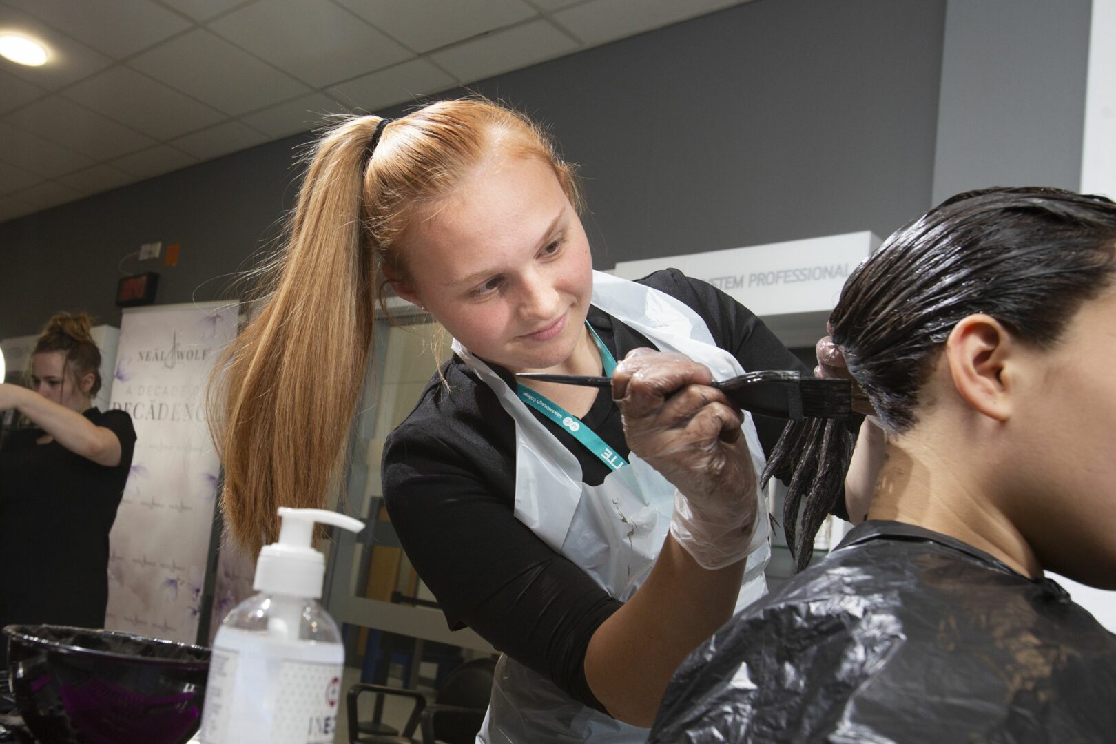 Hairdressing student dyeing hair