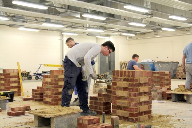 Students building with bricks