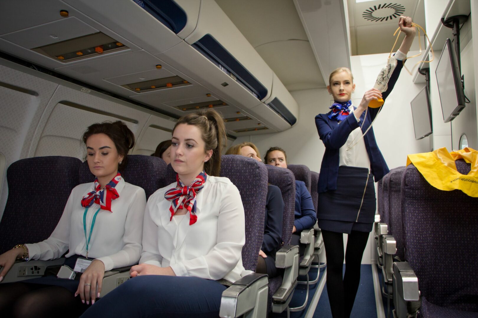 Student showing oxygen mask in simulated aircraft cabin