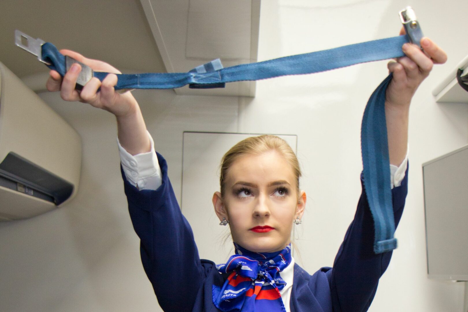 Student showing aircraft seatbelt