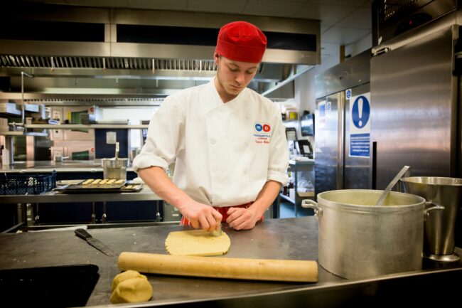 Student cutting pastry