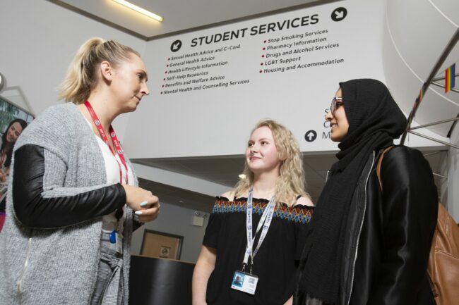 Staff member with students outside Student Services