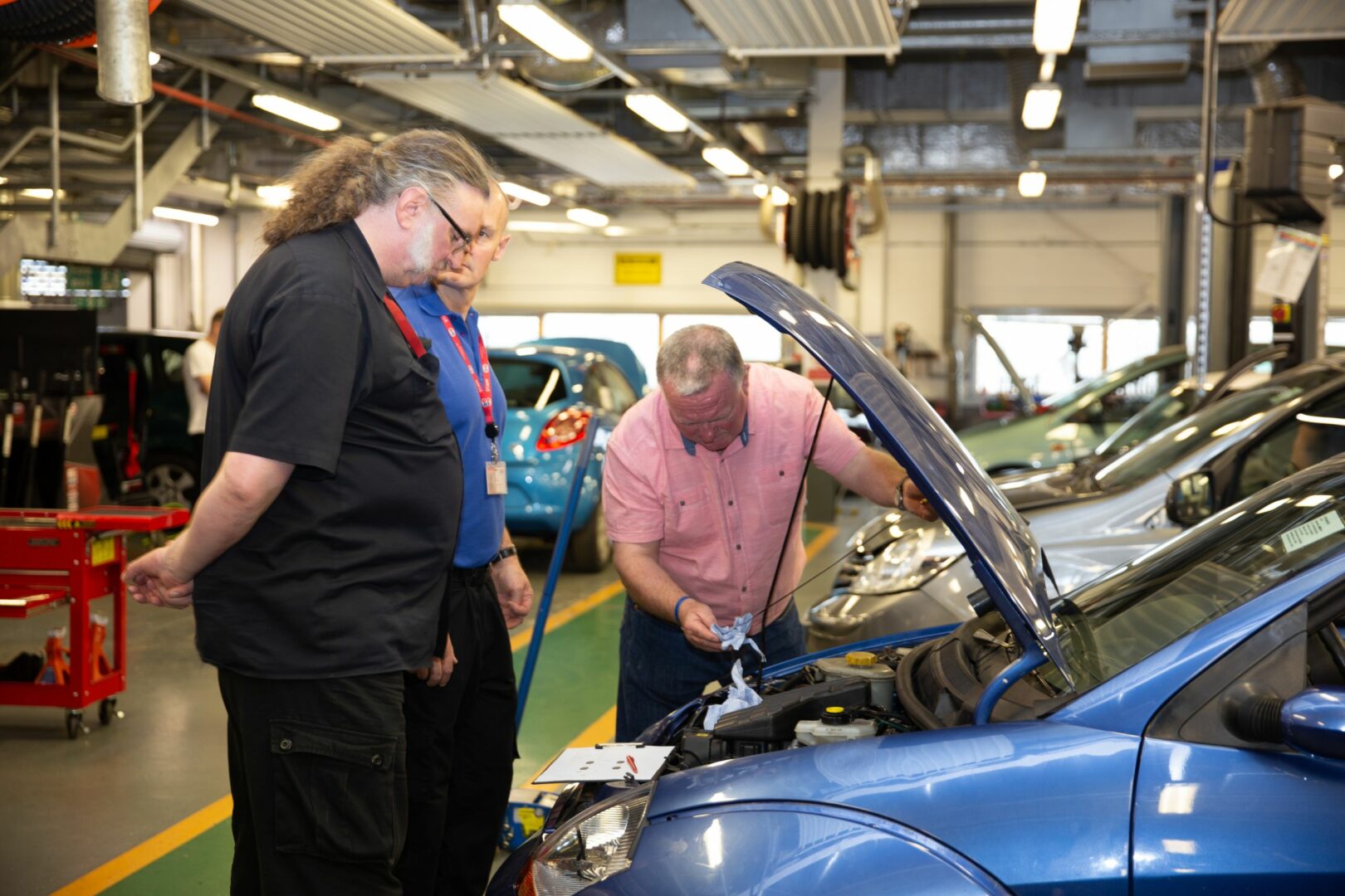 Staff looking at car