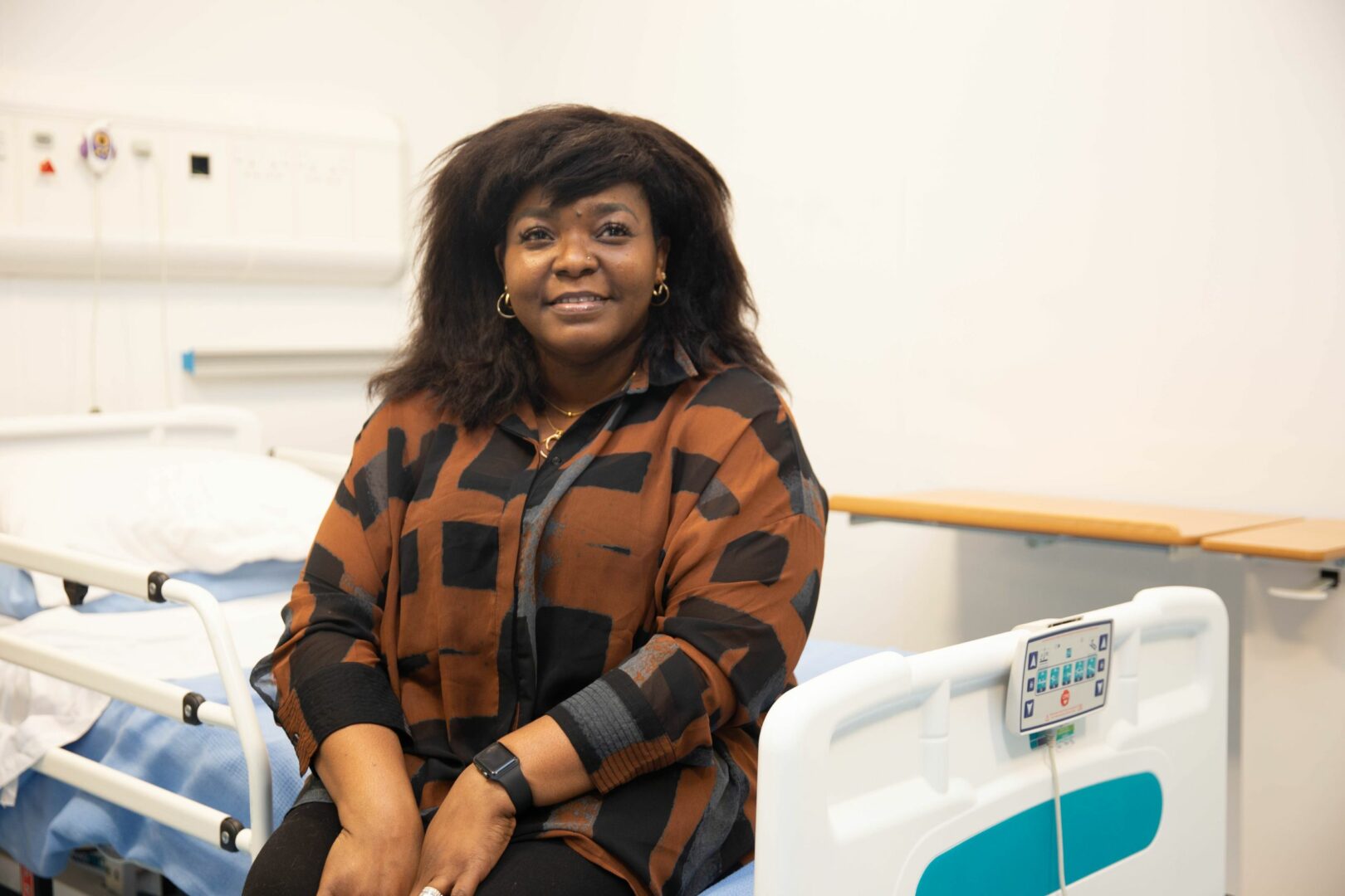 Julian Nwosu sitting on ward bed