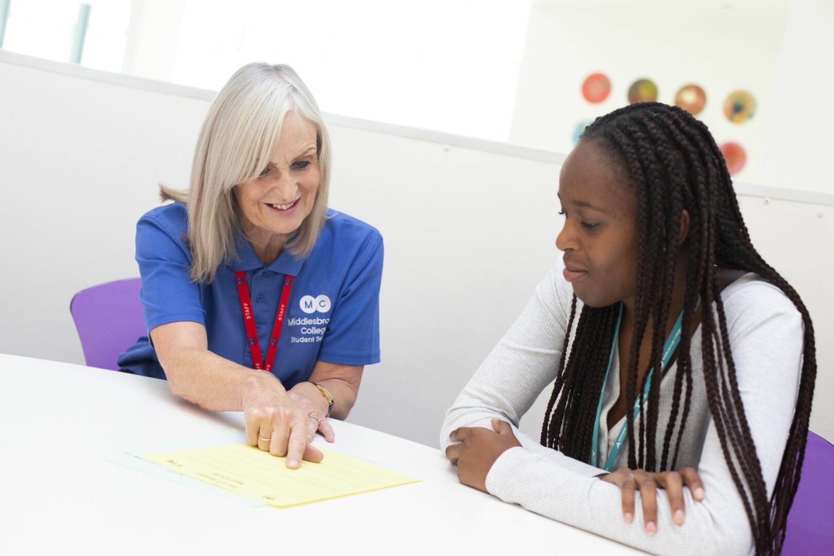 Student service staff member with student