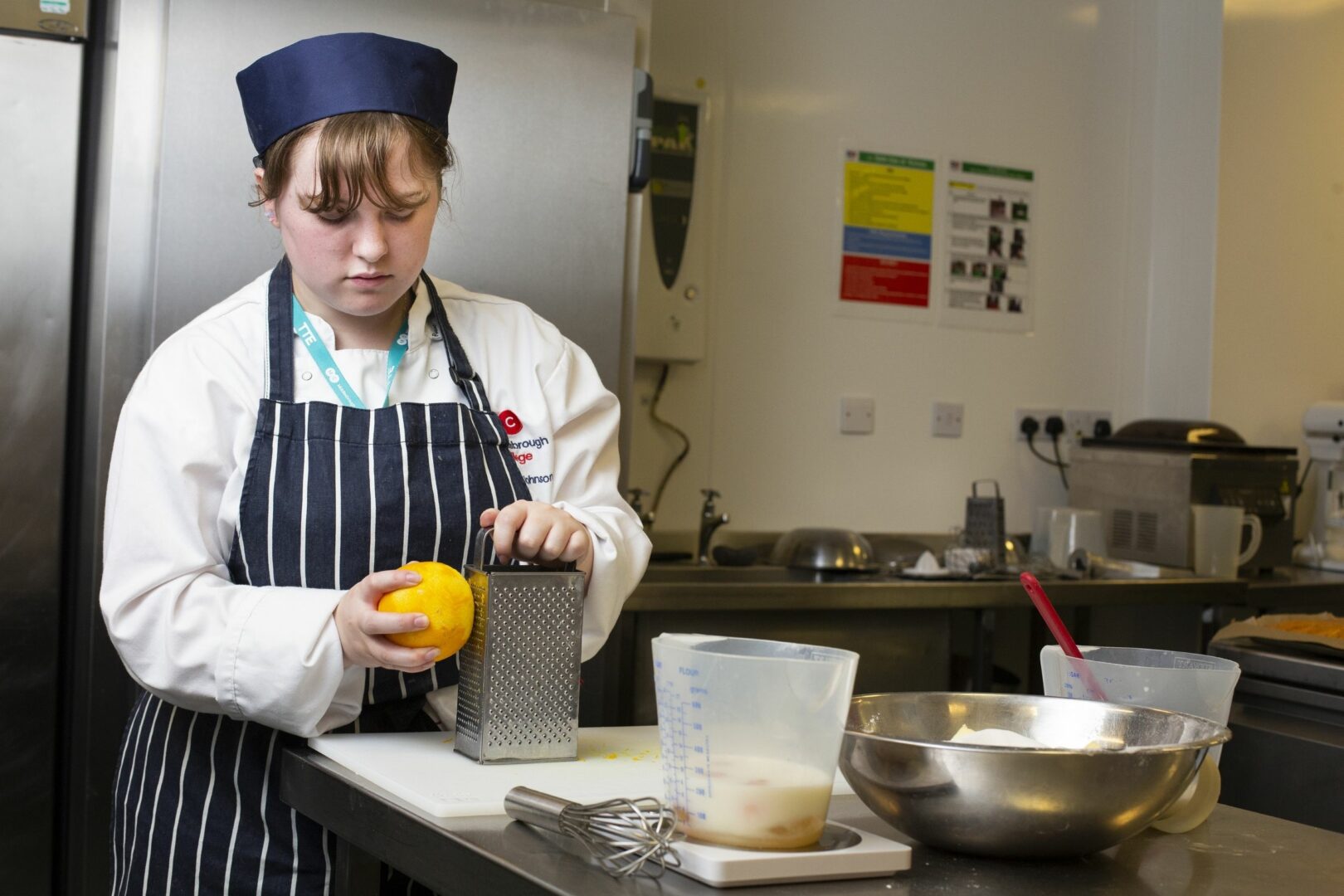 Catering student zesting a lemon