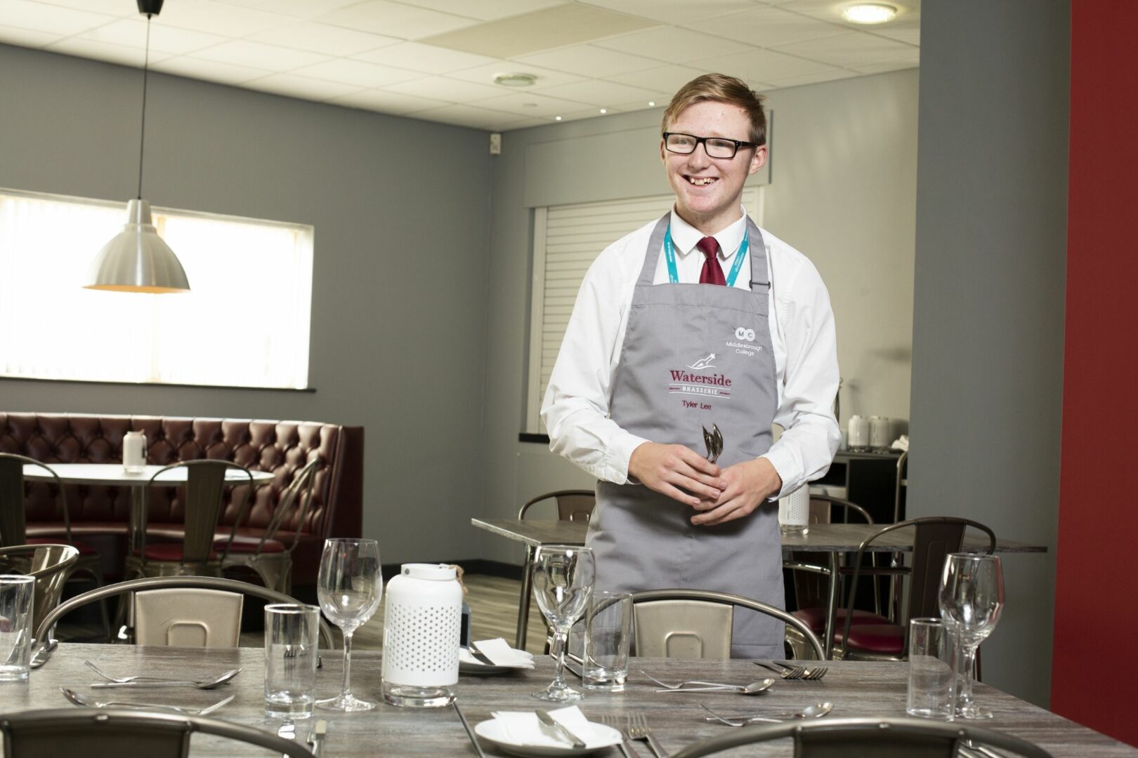 Hospitality student preparing table