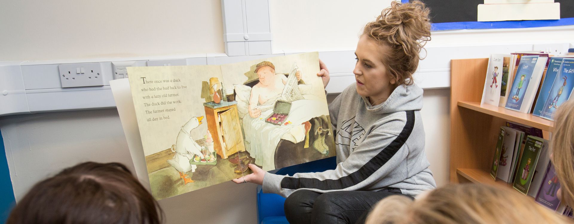 Childcare student reading story book