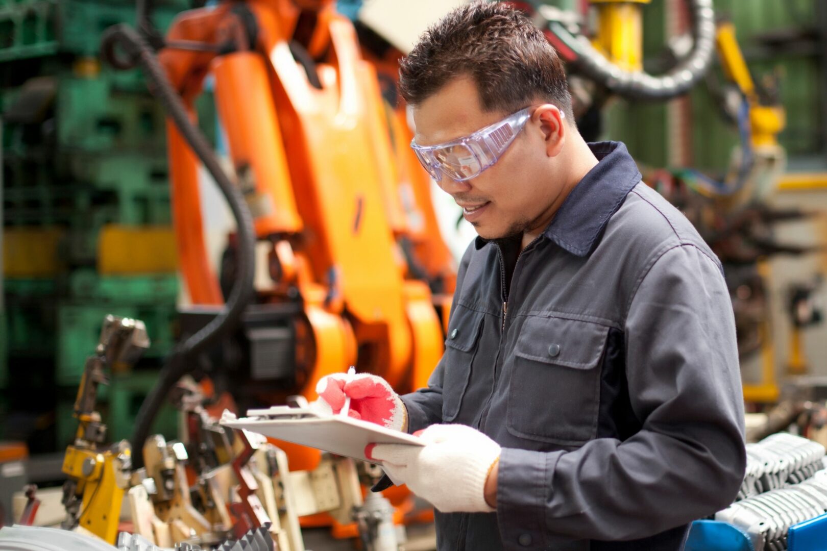 Male engineer on construction site holding clip board