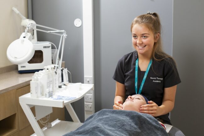 Beauty therapy student giving facial