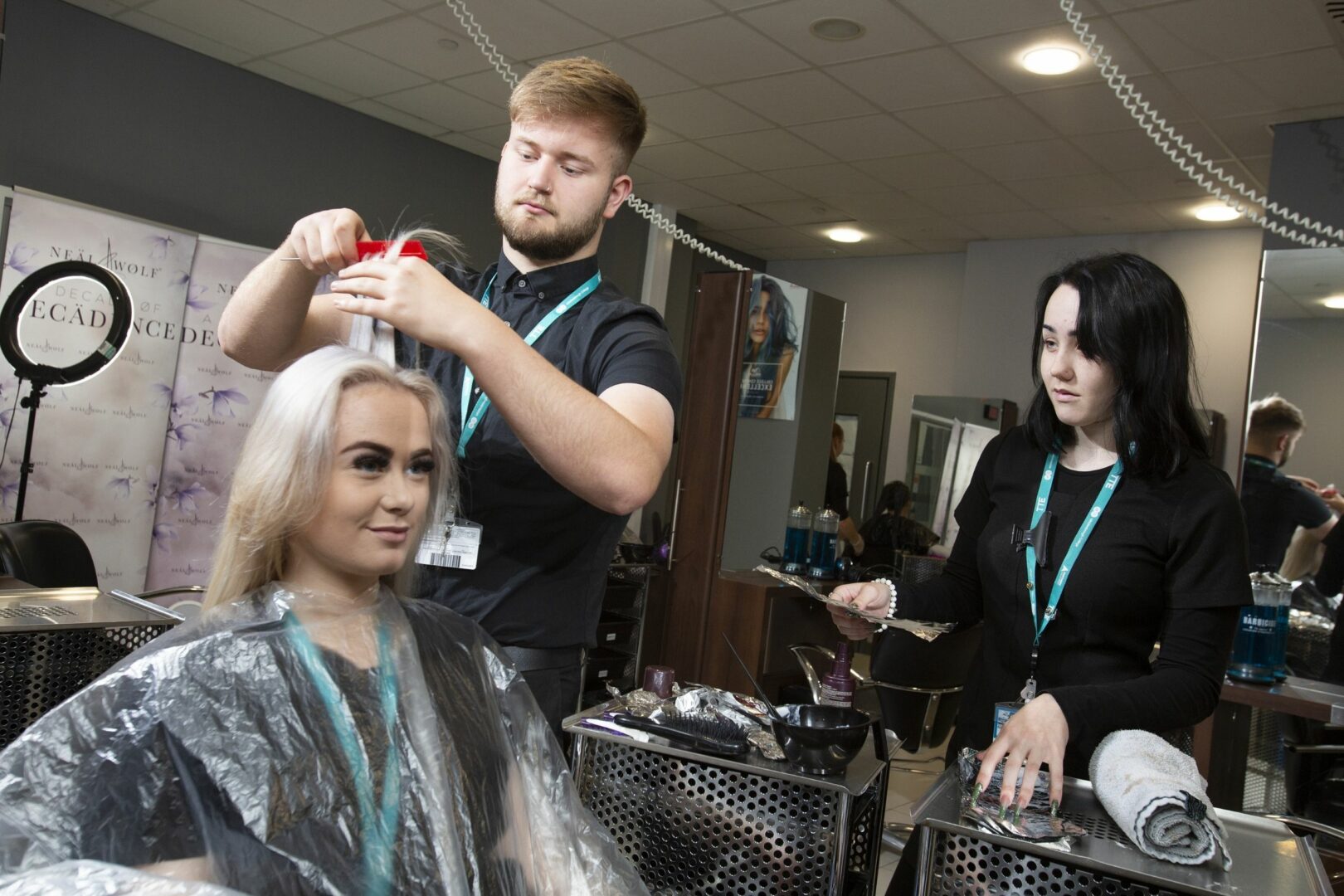 Hairdressing students cutting hair