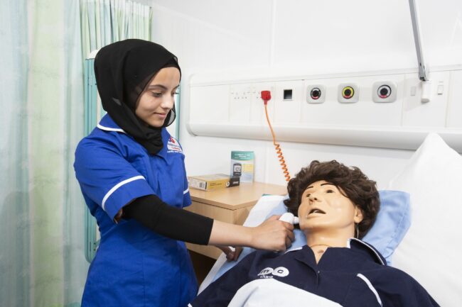 Healthcare student with dummy