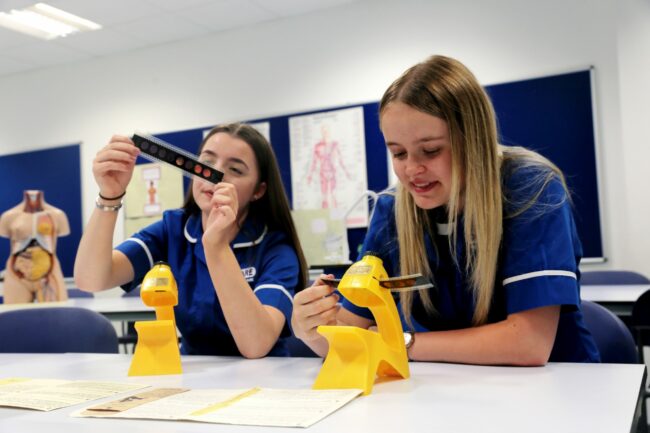 Healthcare students looking at samples