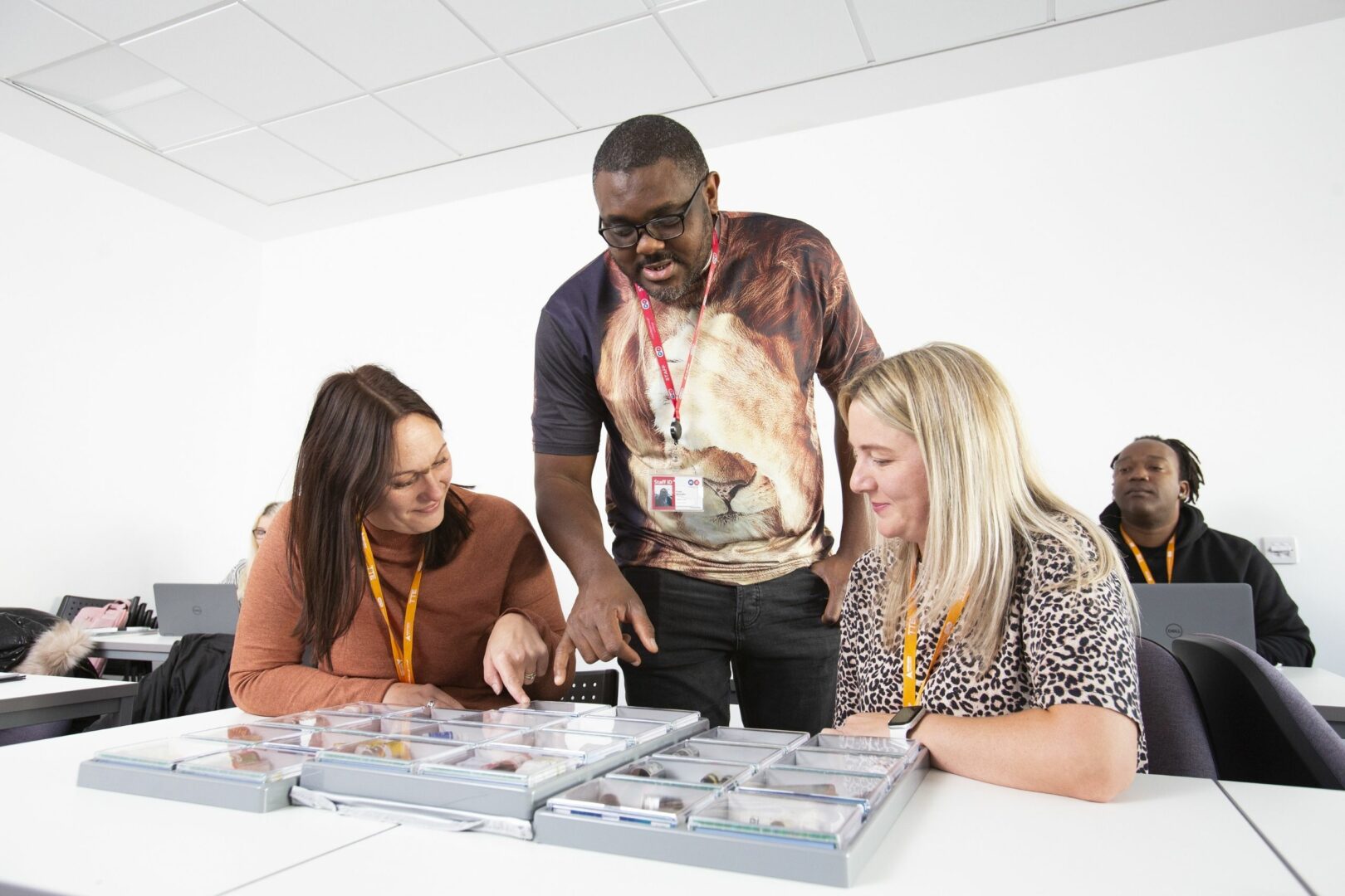 Tutor and students looking at coursework