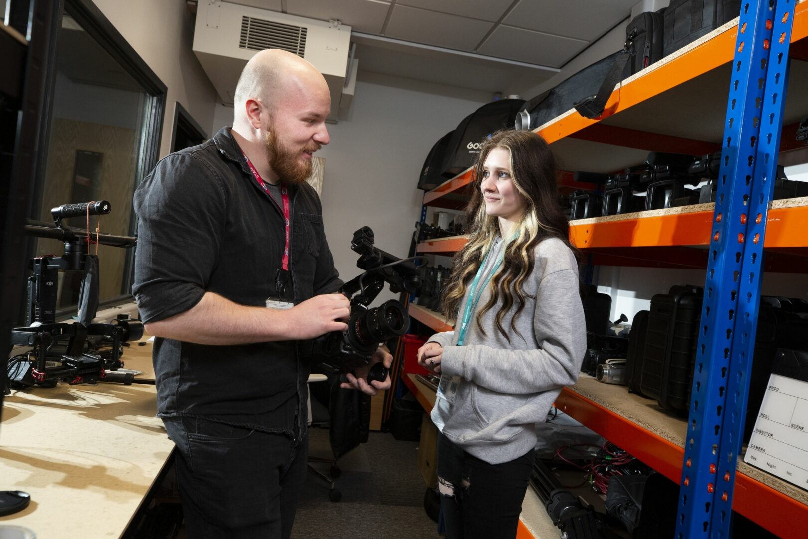 Media tutor and student looking at camera