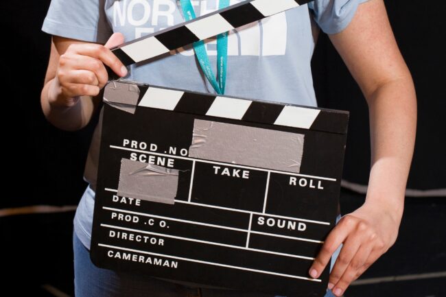 Hands holding clapperboard