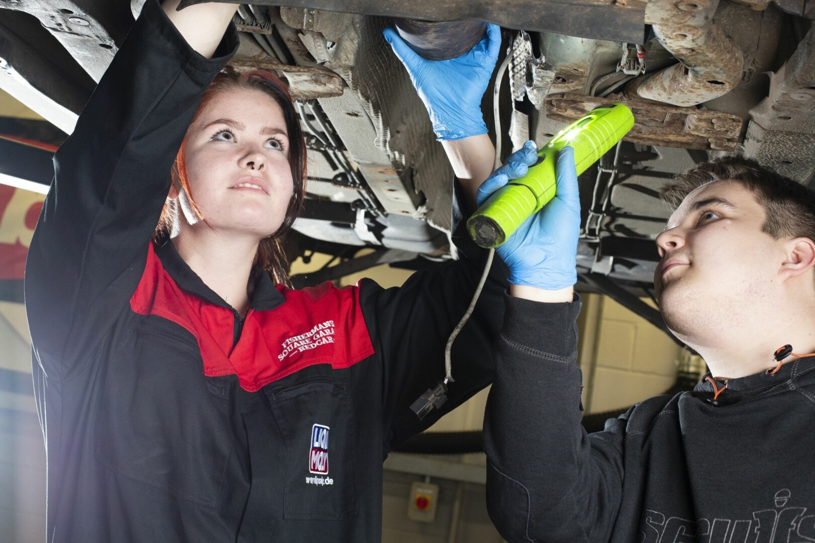 Motor vehicle students working on car