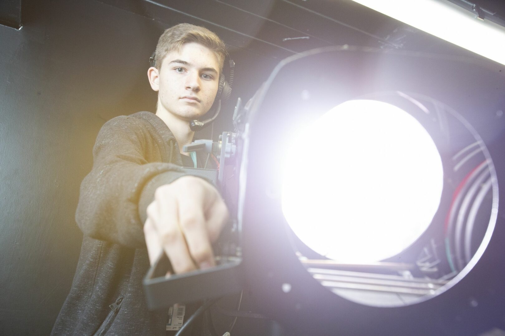 Production student holding stage light