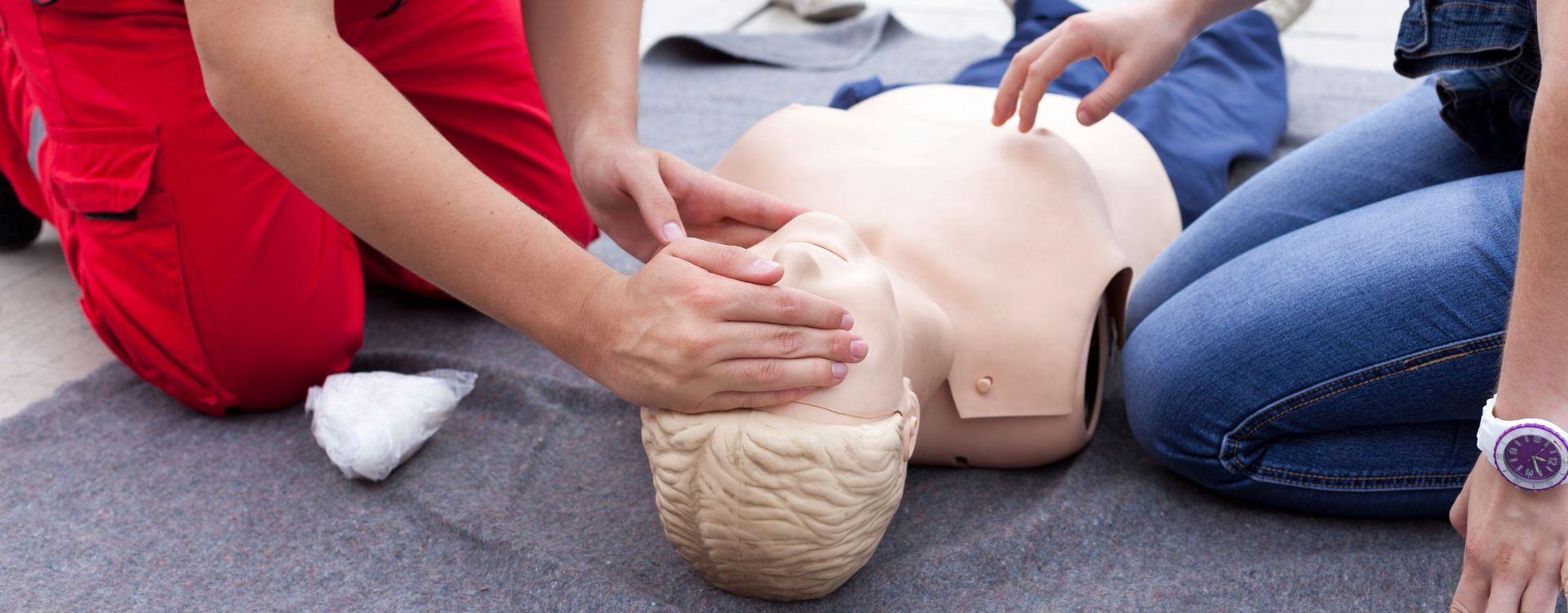 People practising CPR on a dummy