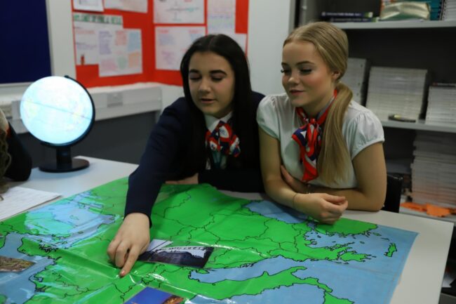 Two travel students looking at map