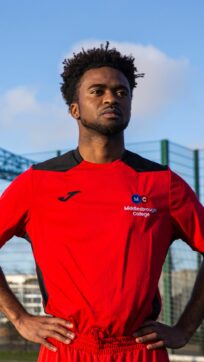 Sports student wearing red football kit