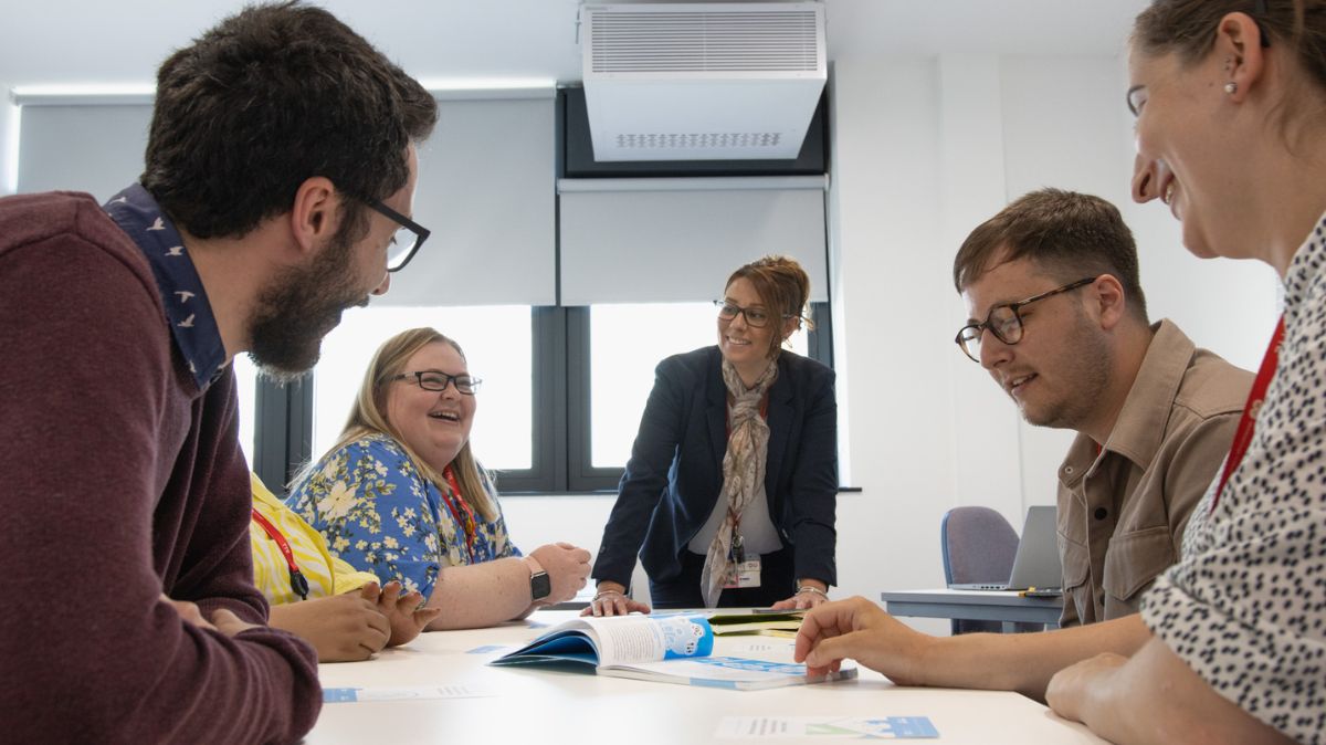 Staff members around a table