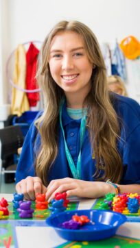 Childcare student working with toys