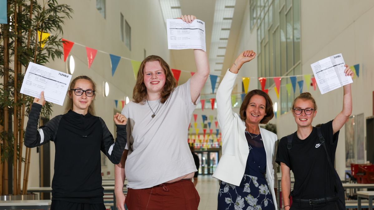 Students with Zoe Lewis holding up results