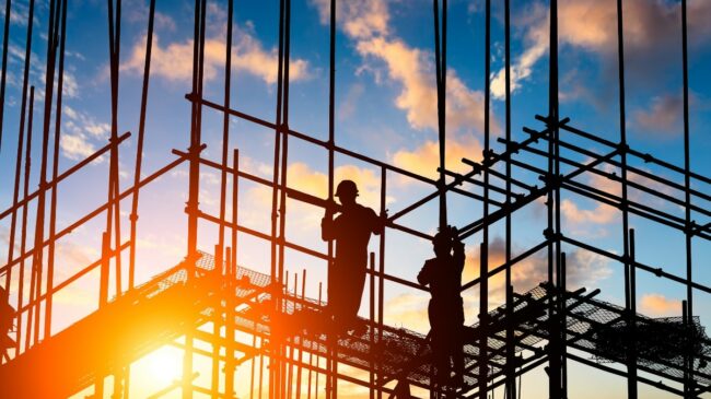 Builders standing on scaffolding