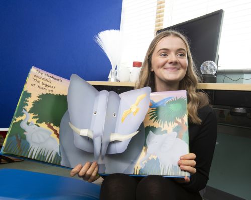 Childcare student reading children's book