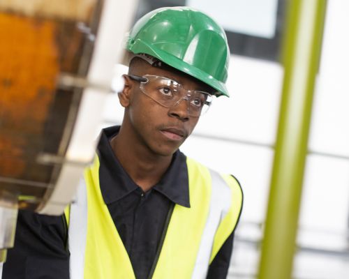 Engineering student wearing hard hat and high visibility vest