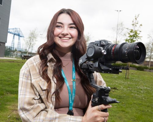 Student holding camera