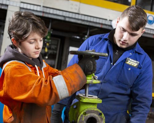 Two TTE student working on mechanical equipment