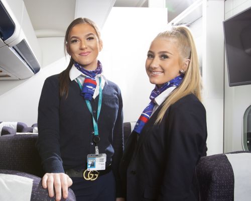 Two travel and tourism students in aircraft