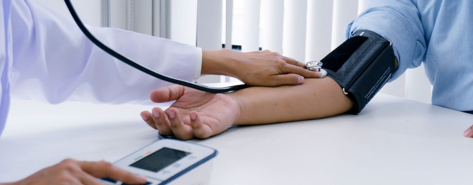 Health worker checking blood pressure