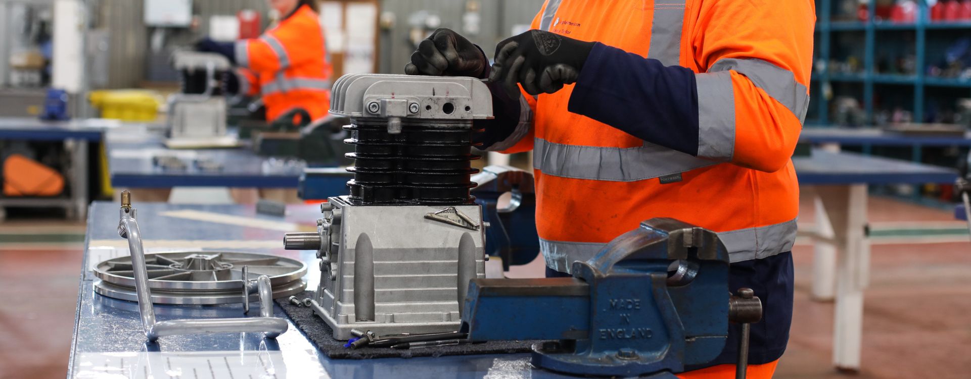 People working on mechanical equipment