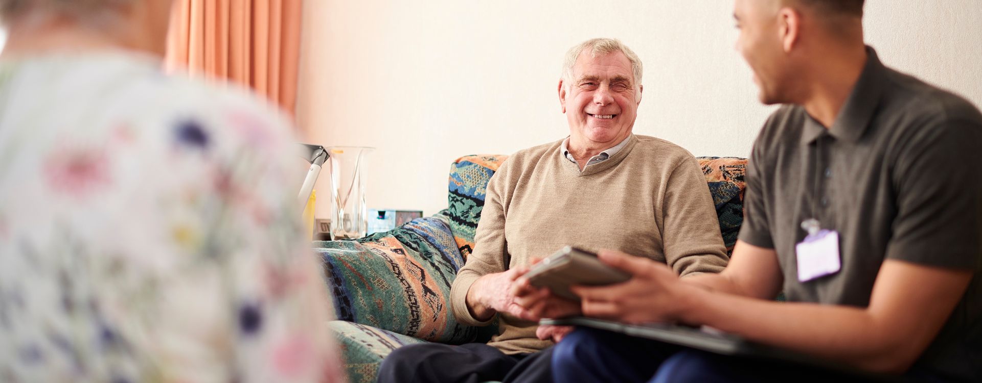 Elderly man talking to a social worker