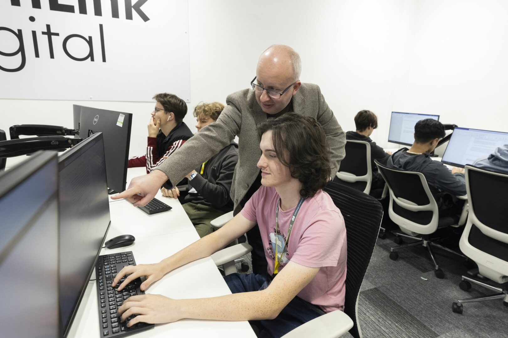 Digital students in computer lab with tutor