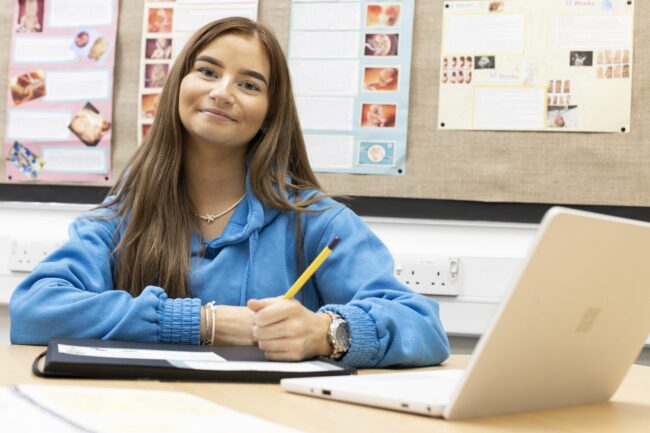 Childcare student working on laptop