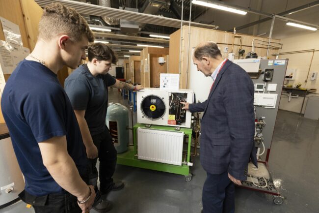 Tutor and students looking at radiator equipment