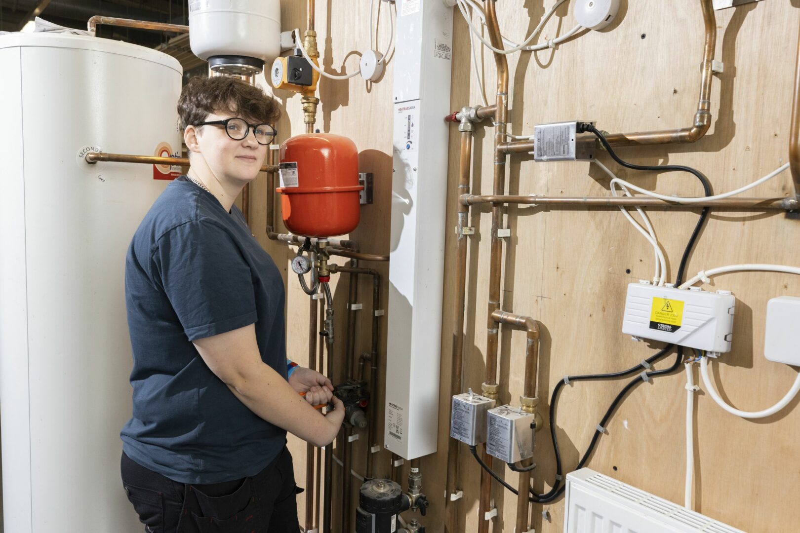 Plumbing student working on pipes