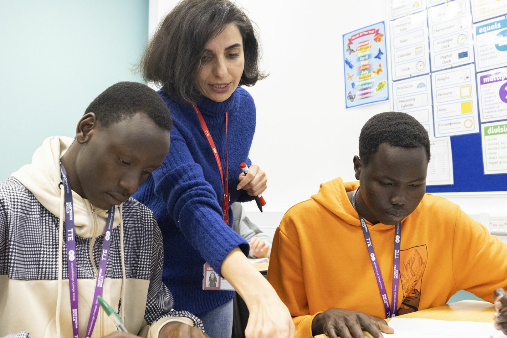 Tutor teaching two ESOL students