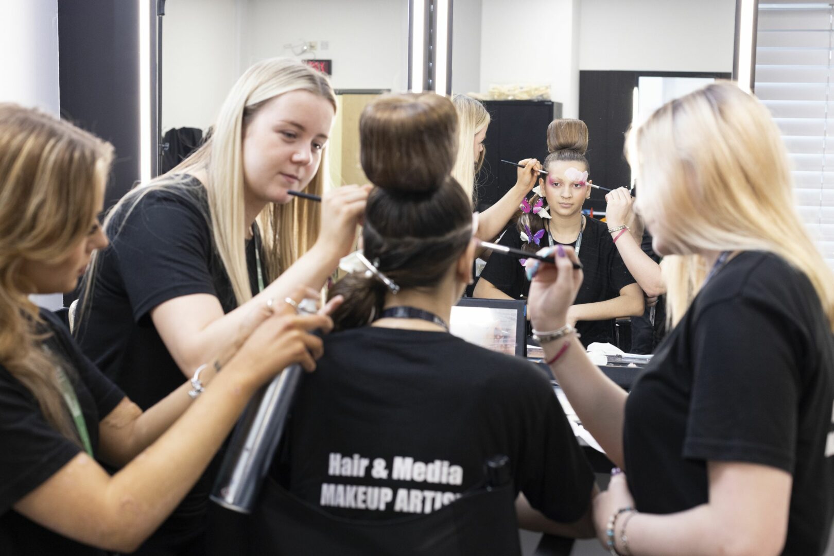 Media Makeup students preparing another student