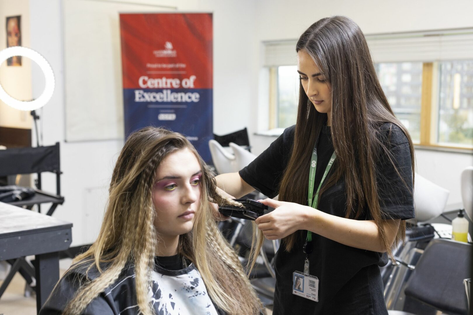 Hairdressing student styling hair